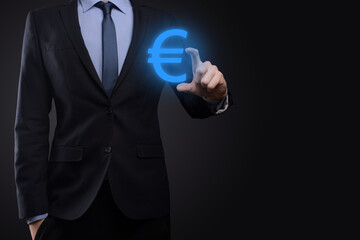 Businessman holds money coin icons EUR or Euro on dark tone background..Growing money concept for business investment and finance