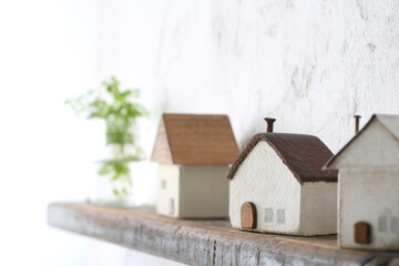 木でできた家の模型とマイホームの設計図のイメージ