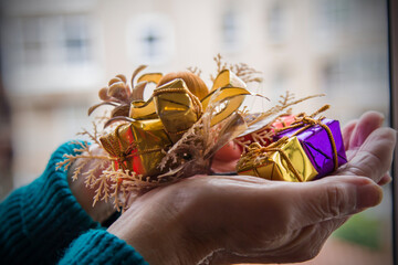 hands holding christmas decorations, merry christmas card
