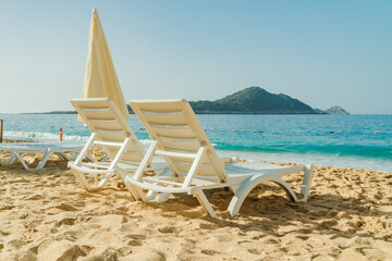 Lounge chairs and umbrellas on Kaputas Beach at summer day