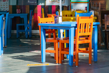 Fototapeta na wymiar Colored chairs, a street outdoor cafe in the Turkish city of Kas