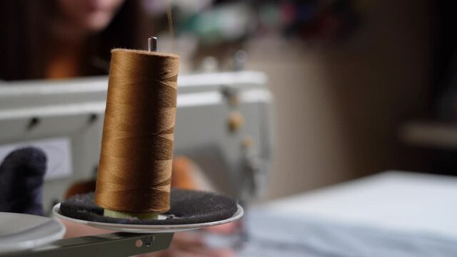 warp threads in a sewing machine, close-up. The work of a seamstress.
