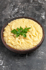 bottom view mashed potatoes in bowl on dark background
