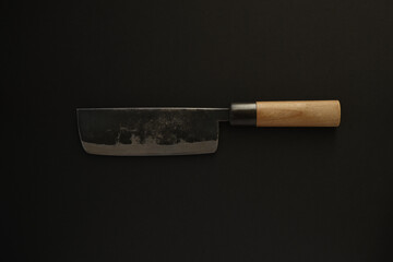 Japanese kitchen knife on black background.