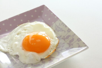 Sunny side up fried egg on dish for breakfast