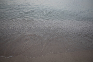 Water surface abstract  background, play of speck of ligth, motion blur, gray brown blue marine gradient.