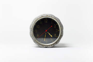 Close-up of vintage alarm clock isolated on white background.