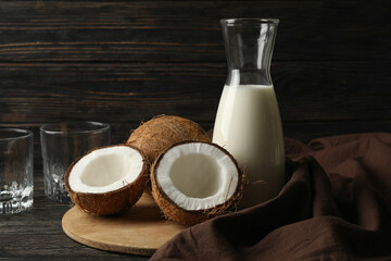 Fototapeta na wymiar Fresh coconut and coconut milk on wooden background