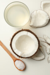 Fresh coconut and coconut milk on white background, top view