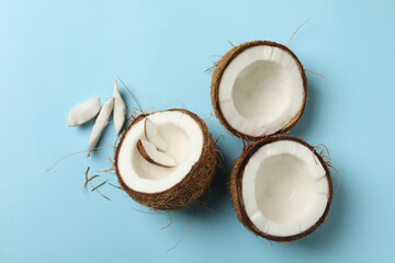 Fresh tasty coconut on blue background, top view
