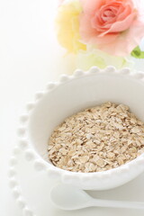 Healthy food ingredient, oatmeal in white bowl with copy space