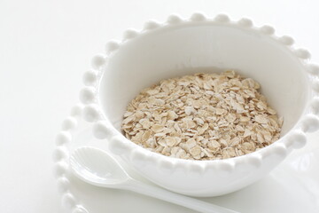 Healthy food ingredient, oatmeal in white bowl with copy space
