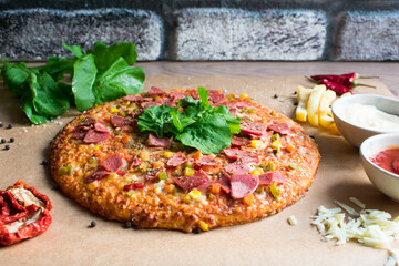 Fresh pizza with tomato, cheese, sausage, salami. Traditional Italian fast food.