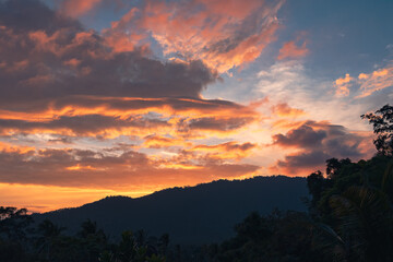 Panorama of a forest valley with mountains at colorful sunset. View from the balcony.