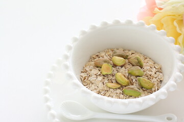 Healthy food ingredient, oatmeal in white bowl with copy space
