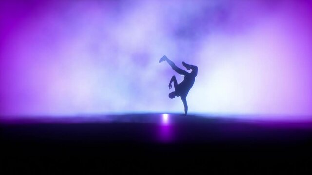 Breakdancer dancing on a stage against colorful spotlights in slow motion, Luma Matte
