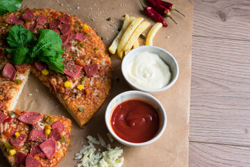 Fresh pizza with tomato, cheese, sausage, salami. Traditional Italian fast food.