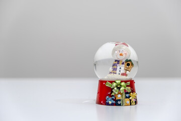 Red snow globe object. Close-up snow globe. It is a symbol of Christmas and winter. Banner concept for new year and celebration.