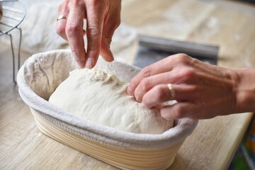 women's hands prepare a pie in the home kitchen