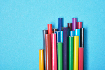 color pencils on blue background copy space