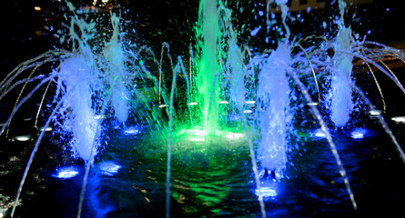 City fountain at night. Selective focus with shallow depth of field.