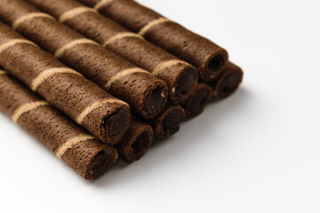 Chocolate wafer rolls on a white background