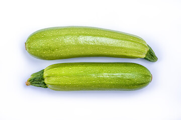 Courgette or Zucchini - green spotted vegetable for cooking vegetarian and healthy food, agricultural product isolated on white background