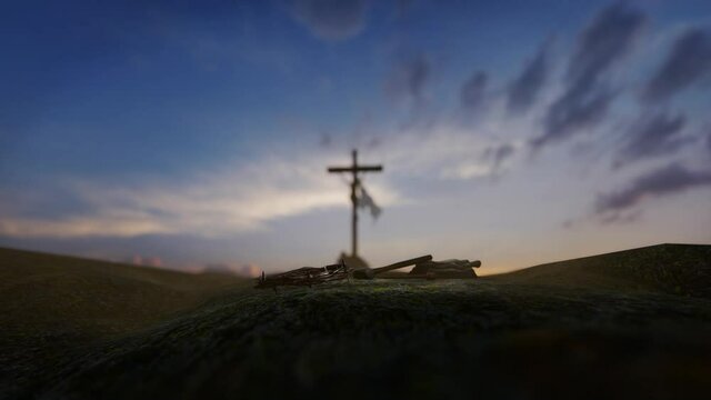 Crucifixion of Jesus Christ with thorn crown, nails, hammer and a rope against beautiful sunrise, til