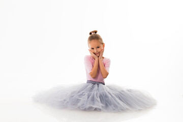 Fototapeta na wymiar Little ballerina posing on a white background