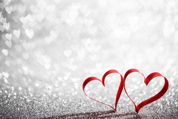 Red ribbon hearts on glitters