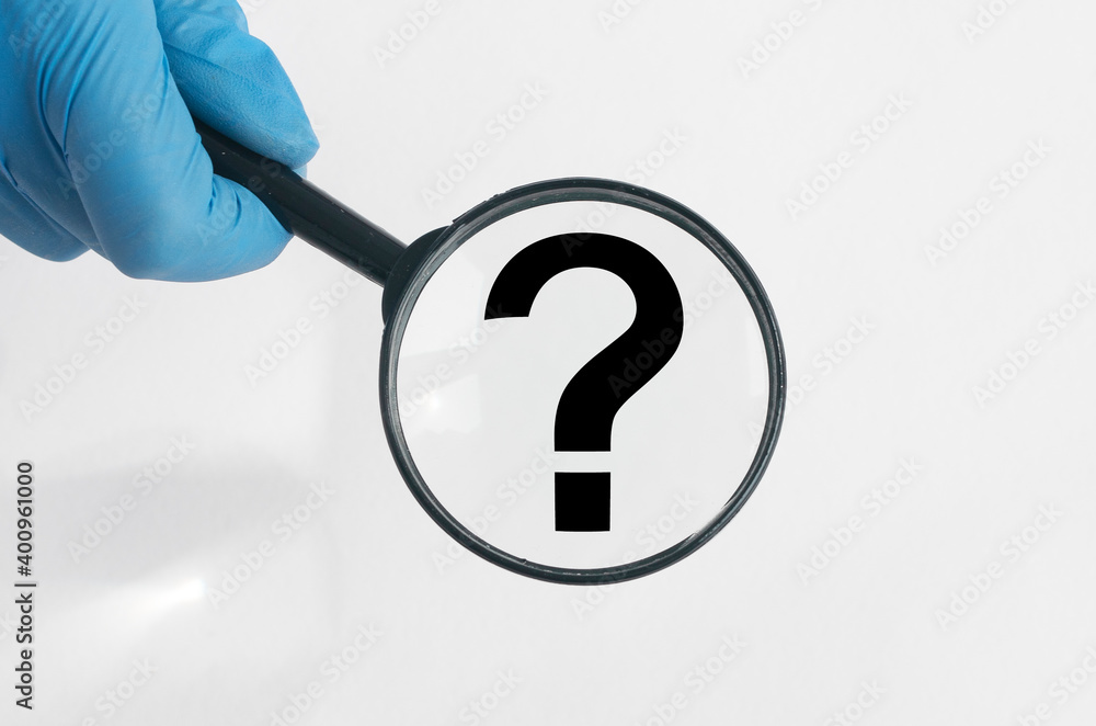 Poster question or interrogation mark through magnifier. searching for answers concept