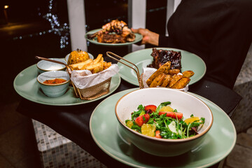 A waitress in a posh Lagos restaurant carries a customer's food order. 