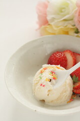 Vanilla ice-cream served with sliced strawberry