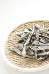 Fototapeta na wymiar Japanese food ingredient, dried small sardines on bamboo basket for broth cooking