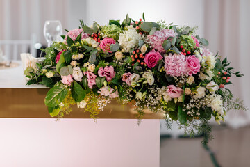 Luxury holiday or wedding table, richly decorated with beautiful floral bouquets. Floral compositions with fresh roses.