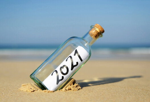 Happy New Year 2021. Holidays Summer 2021. Message in a bottle. Sun and beach vacation concept 