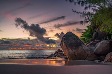 sunset at tropical beach anse georgette on praslin, seychelles