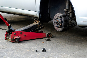 Mechanic screwing or unscrewing changing car wheel by wrench mechanic at work changing a wheel on a car