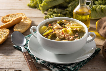 Creamy Tuscan soup in bowl on wooden table	