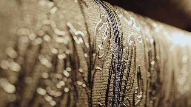 Rolls with wallpaper. Ornament close-up. Stand with wallpaper in the store