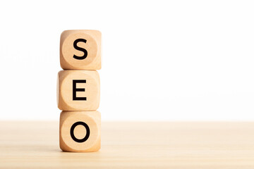 SEO word in wooden blocks on table. Copy space