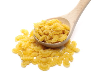 Pasta cornetti creste macaroni pile with wooden spoon isolated on white background