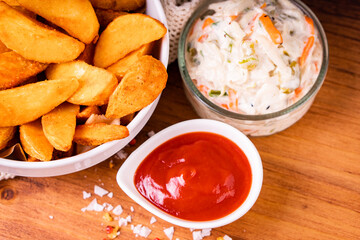 Tradition french fries from organic bio potato wedges with skin dip in ketchup