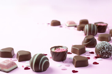 Chocolate candies  assortment on pink background with  copy space .. Valentines  and mother day postcard .