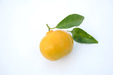 the ripe orange fruit with green leaves isolated on white background.