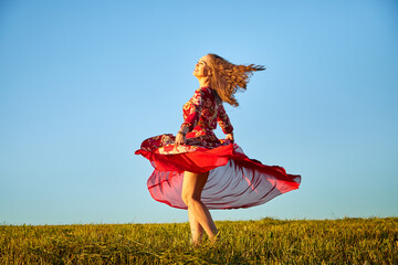 Beautiful woman or girl with magnificent figure and plastic movements walking and dancing in green...