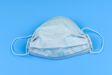 Protective face mask on a blue background. Healthcare and medicine concept