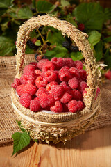Fototapeta na wymiar Blackberry with raspberries on a wooden background