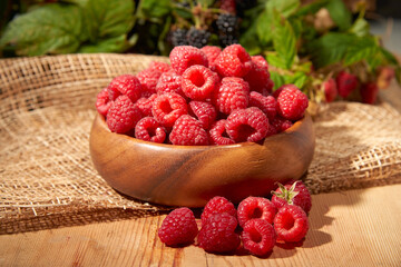 Blackberry with raspberries on a wooden background