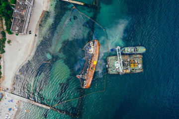 Top view of an old tanker that ran aground and overturned